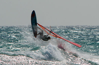 People on sea against sky