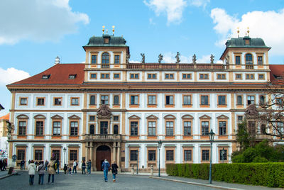 People walking in front of historical building