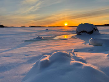 Scenic view of beach against sky during sunset