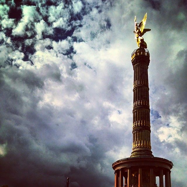 low angle view, statue, sky, sculpture, human representation, architecture, cloud - sky, art and craft, built structure, art, cloudy, building exterior, famous place, creativity, travel destinations, cloud, international landmark, history, travel