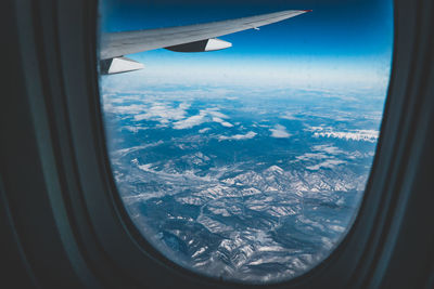 Aerial view of mountains seen through airplane window