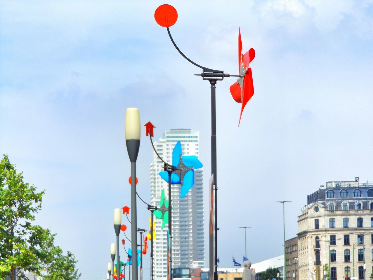 LOW ANGLE VIEW OF FLAGS HANGING ON POLE AGAINST SKY