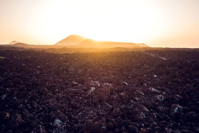 Scenic view of landscape against sky during sunset