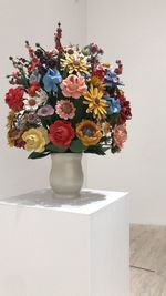 Close-up of flower pot on table against wall