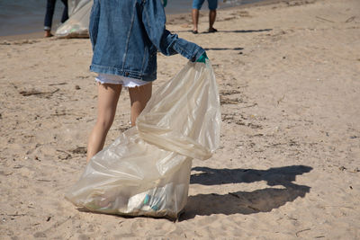 Low section of woman walking on beach