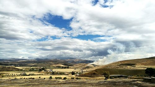 Scenic view of landscape against cloudy sky