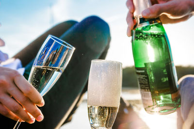 Close-up of person holding glass bottle