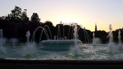 Water splashing in fountain against clear sky