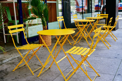 Yellow decorative table and chairs at cafe in city street. street cafe in european city.