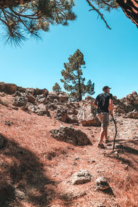 Man on rock against sky