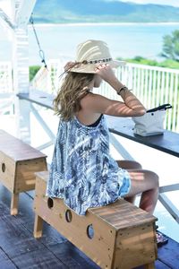 Full length of woman sitting on chair