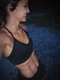 Woman looking away while standing at night