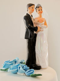 Mother and son on floor against white background