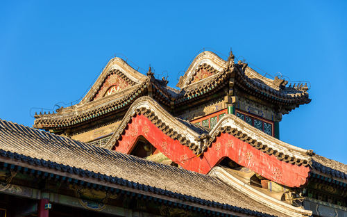 Low angle view of building against clear blue sky