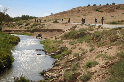 Soldiers from the syrian armed opposition are walking on the road