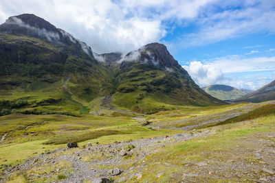 Scenic view of mountains against cloudy sky