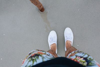 Low section of woman standing on tiled floor
