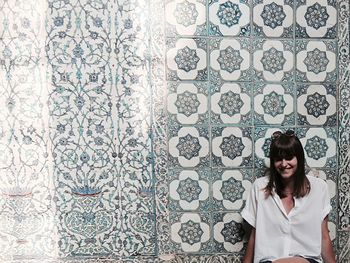 Happy woman against mosaic wall at topkapi palace