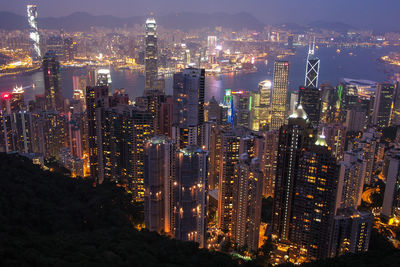 High angle view of illuminated city buildings at night