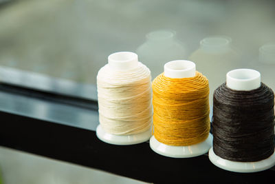 A group of multicolor sewing thread on a window frame and blank for copy space.