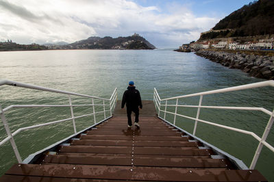Rear view of man standing on stairs