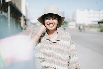 Portrait of smiling young man wearing hat