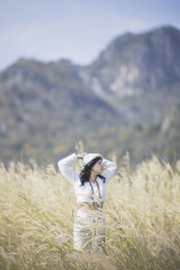 Young woman standing on field