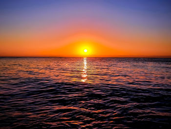 Scenic view of sea against romantic sky at sunset