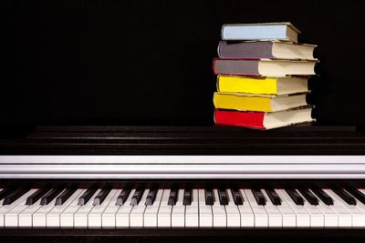 Close-up of multi colored piano against black background