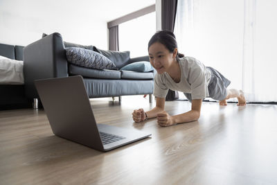 Woman using mobile phone at home