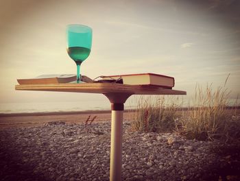 Close-up of wineglass against sky