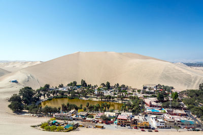 High angle view of town in desert against clear blue sky
