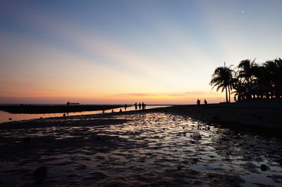 Scenic view of beach against sky during sunset