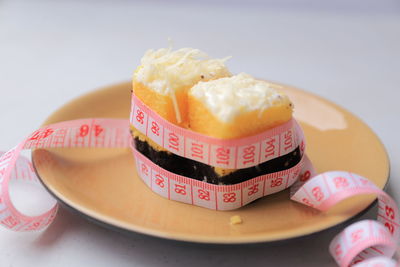 The measuring tape is wrapped around cake, diet concept, healthy concept