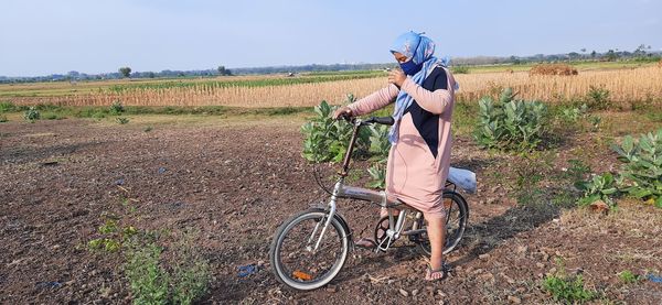 Man riding bicycle on field