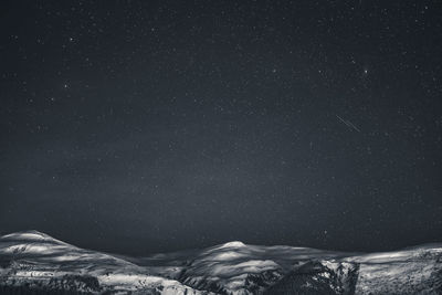 Scenic view of mountain against sky at night