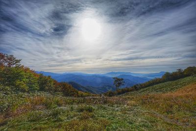 Countryside landscape against mountain range