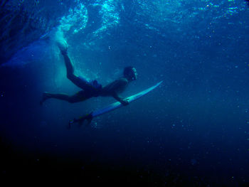 View of surfer swimming in sea