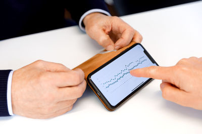 Cropped hands of man using digital tablet