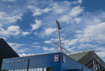 Low angle view of text on building against sky