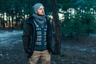 Man smoking cigarette in forest