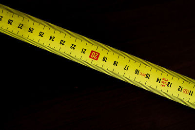 Close-up of number on table against black background