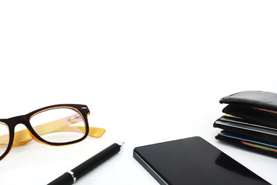 Close-up of books on table against white background