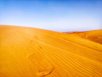 Scenic view of desert against clear sky