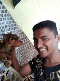 Portrait of smiling young man with dog
