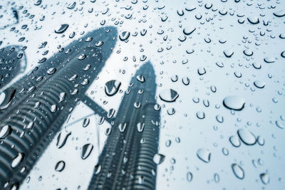 Waterdrops on glass against petronas