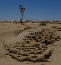 Sand dune in desert against clear sky