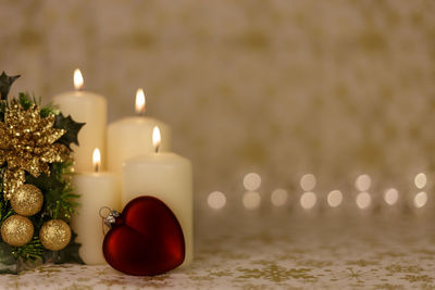 Close-up of christmas decorations with candles on table