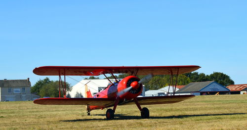 View of airplane on field against clear sky