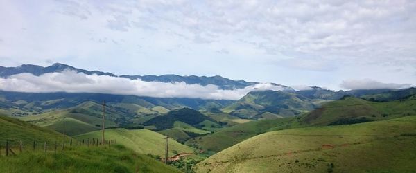 Scenic view of mountains against cloudy sky